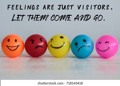Feelings are just visitors, let them come and go, wording on background with emotional balls : smiley face ball in yellow orange and pink, sad ball in blue and madness ball in red.  - Shutterstock ID 718143418