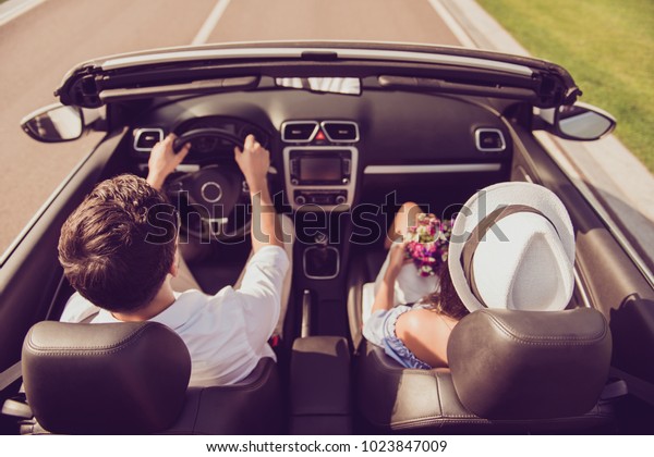 Feelings, married family, friendship, reach\
destination, escape, speed ride lifestyle. Carefree driver husband,\
lady wife with gift present on their way to dreams and happiness,\
highway, honeymoon