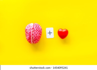 Feelings And Mind Concept With Brain Plus Heart On Yellow Background Top View