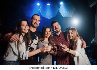 It Feels So Good To Be Together Again. Group Of Young Friends Smiling And Making A Toast In The Nightclub.