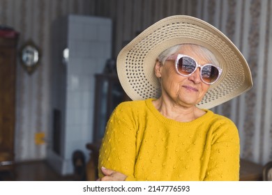 Feels Like Summer. Cute Senior Woman In Hat And Sunglasses At Home Medium Closeup Living Room Seniority Concept. High Quality Photo