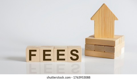 FEES Wooden Blocks With A Miniature House on white background