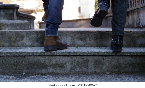 Feet Of Adult Couple Going Up The Stairs