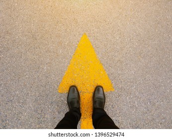 Feet and arrows on road.  - Shutterstock ID 1396529474