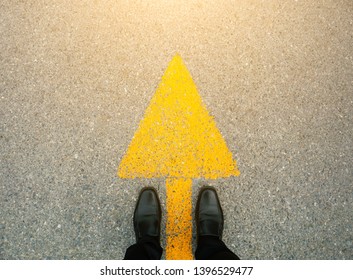Feet and arrows on road.  - Shutterstock ID 1396529477