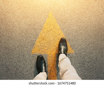 Feet and arrows on road. - Shutterstock ID 1674751480