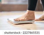 Feet of an Asian woman on a weight scale