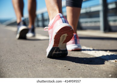 Feet Of An Athlete Couple Running On A Pathway Training For Fitness And Healthy Lifestyle.