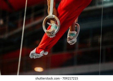 Woman holding gymnastic rings in gym