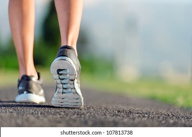 Feet Of An Athlete Running On A Park Pathway Training For Fitness And Healthy Lifestyle