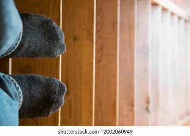 Feet In Black Socks On The Stairs