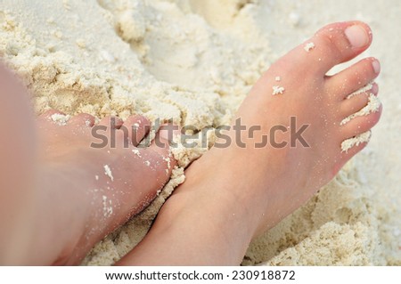 feet buried in the sand