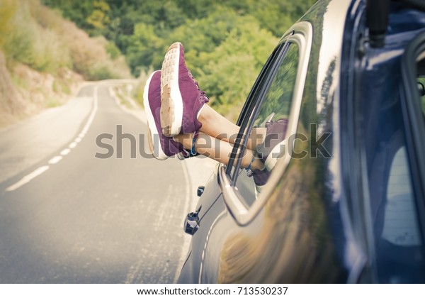 feet in\
the car window, concept of travel and\
vacation