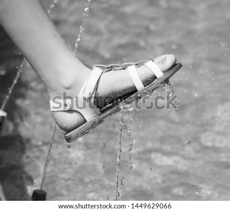Feet of a child in a fountain