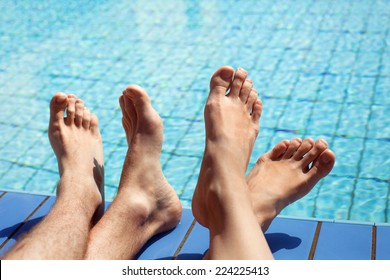 Feet Of Couple Near Swimming Pool