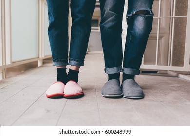 Feet Of A Couple Of Young Man And Woman Wearing Slippers Indoor Apartment 