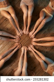 Feet Of Dancers Seated Circle On The Floor