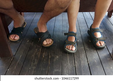 Feet Of The Father And Son Under The Table.