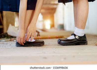 feet of female students wearing black student shoes - Shutterstock ID 1536998636