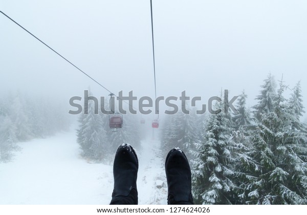 Feet in front of Chair\
lift
