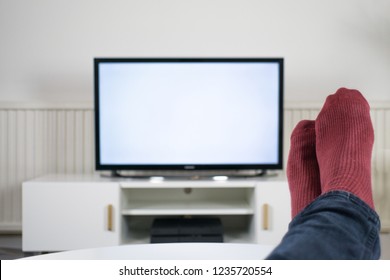 Feet up in front of TV with a blank screen