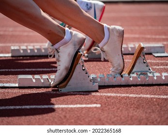 Feet Girls Runner Sprinter Track In Starting Blocks. Athletic Training On Stadium