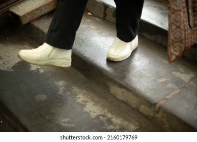 Feet Go Up Steps. White Shoes. Move Up Stairs. Man In Town.