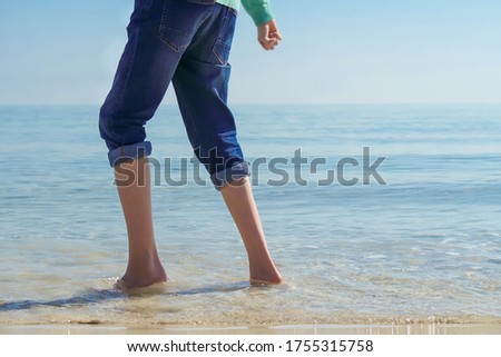 Feet of a happy child at the beach