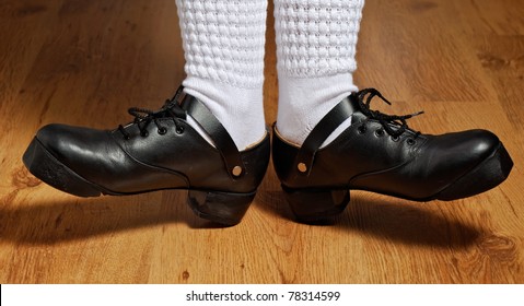 feet in irish dancing step shoes and white socks on parquet - Powered by Shutterstock