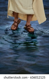 Feet Of Jesus With Sandals Walking On The Water