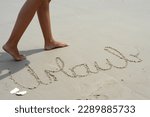 feet and legs on beach with painted vacation (Urlaub)