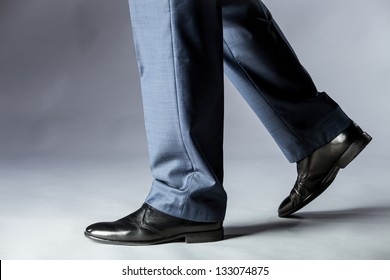 Feet of man in black shoes