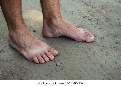 feet of a man on the ground