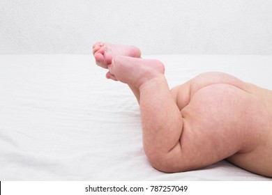 Feet Of Newborn Baby On Changing Table In His Bed. Cute Little Girl Or Boy Three Month Old. Dry And Healthy Body And Skin Concept. Baby Nursery. Copy Spase