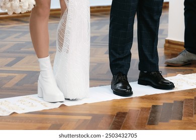 The feet of the newlyweds on the handkerchief. Wedding traditions of Ukraine. - Powered by Shutterstock