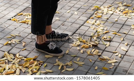 Feet on an autumn sidewalk