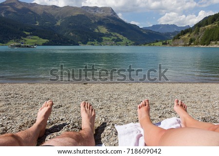 Feet on the beach, relaxing at the Reschensee - Italy