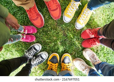 Feet On Green Grass, Standing In A Circle. Top View.