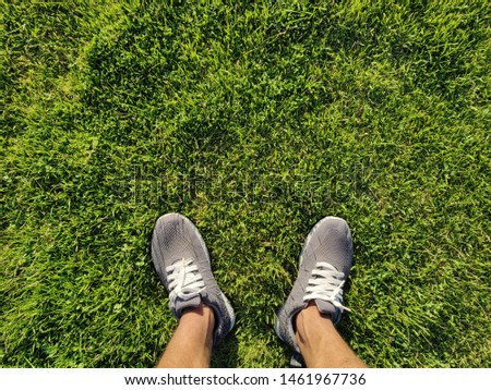 Feet on green grass Walking exercise outdoors in spring park.