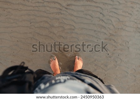 Feet on the sand at the beach at dusk,travel