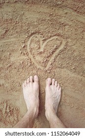feet on the sand with heart, love for walking on the beach barefoot