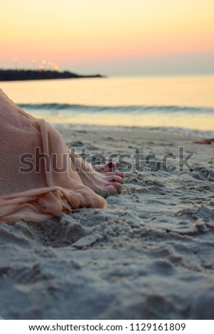 feet on the sand, sunset
