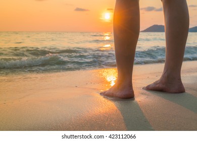 Feet on the sand in sunset time - Powered by Shutterstock