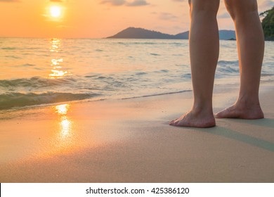 Feet on the sand in sunset time - Powered by Shutterstock