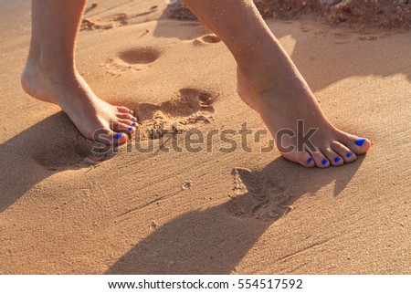 feet on sea sand