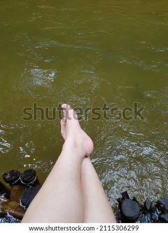Feet over the river relaxing