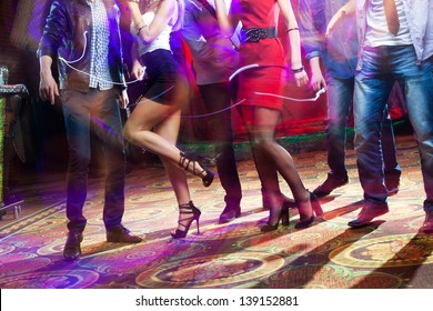 Feet Of People Dancing On A Club Party. Unrecognizable