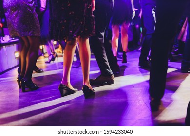 feet of people dancing on a club party. unrecognizable.