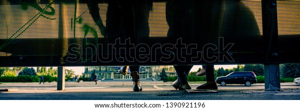 feet of people having\
a rest on a stop against the background of city street. Web banner\
for your design.