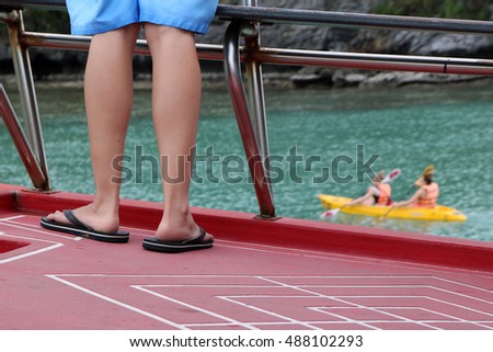 Feet of the people on the tour boat and kayak activities background at ang thong island Thailand.